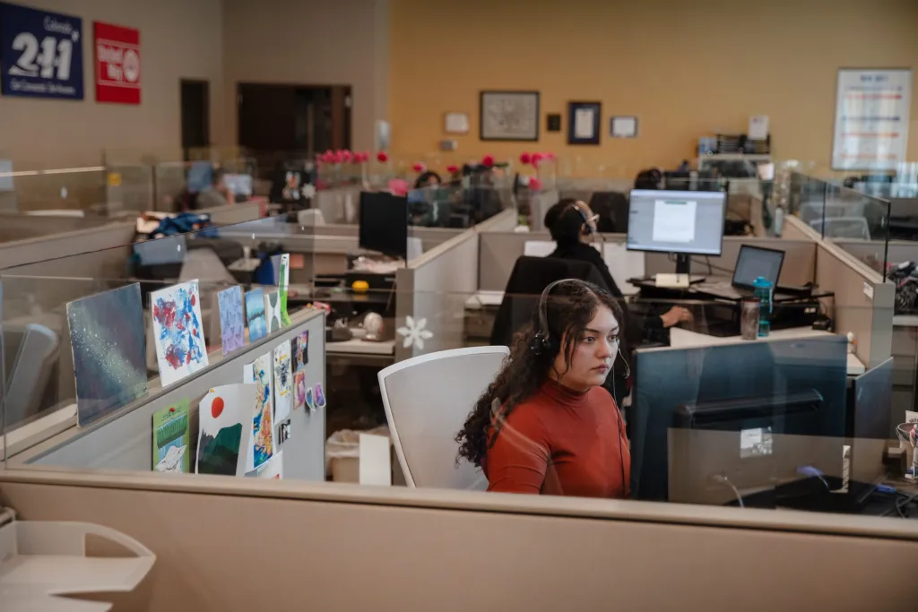 A 2-1-1 Colorado calltaker working at her desk